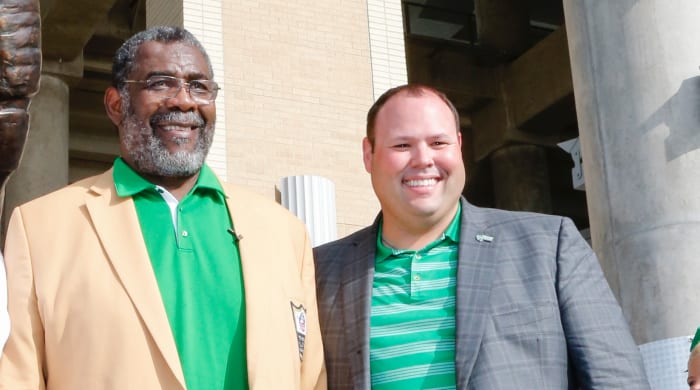 North Texas Athletic Director Wren Baker (right) at the school’s statue unveiling for Hall of Famer “Mean” Joe Greene.